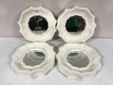 Four scalloped edged framed mirrors