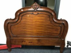 A mahogany Victorian style bed head