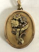 A Victorian two-tone gold oval locket, with floral panel set with seed pearls, 21.4g.