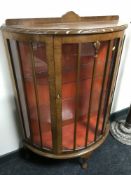 A walnut d-shaped display cabinet