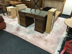 A large fringed pink embossed carpet with floral decoration