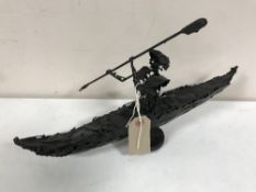 A contemporary metal sculpture by Kenneth Rowden modelled as a canoeist, length 38 cm.