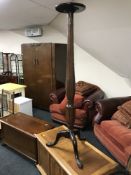 An antique mahogany classical torchere on three way support