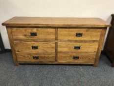 A contemporary oak sideboard fitted with six drawers,