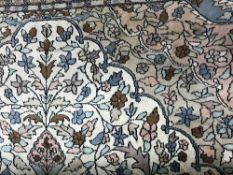 A large Persian Kashan carpet with cream field