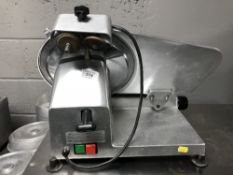 A stainless steel meat slicer