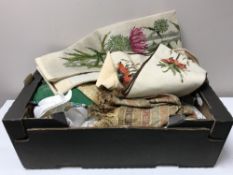 A box of table linen, cushion, fur hats,