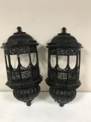 A pair of carved Eastern hardwood wall shelves in the form of pagodas