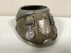 A horse shoe table snuff with plated mounts and inset with two Victorian miniature medals