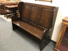 A panelled oak pew,