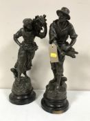 A pair of spelter figures on wooden bases depicting wheat gatherers