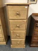 A pine narrow tall four drawer chest,