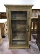 A pine glazed door curio cabinet