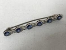 An early twentieth century six stone sapphire and diamond bar brooch, set in white gold,