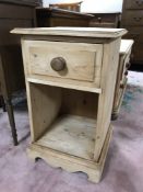 A pine bedside stand fitted a drawer