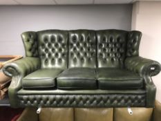 A green buttoned leather three seater Chesterfield wing backed settee (for restoration)