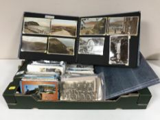 A box of assorted post cards and two post card albums