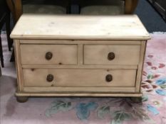 A pine three drawer chest