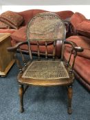 An antique bergere seated armchair