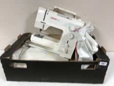 A box of Bernina 1008 electric sewing machine in carry bag and small quantity of table linen