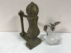 An antique brass fire dog and a glass and plate claret jug