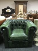 A green button leather Chesterfield armchair