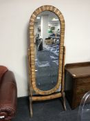 A bamboo framed cheval mirror