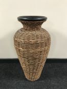 A large pottery and wicker vase,