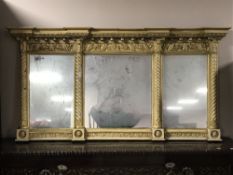 An antique cream and gilt sectional over mantel mirror.