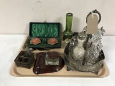 A tray of silver plated cruet set, plated salts, glass inkwell on bakelite stand,
