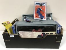A box of car seat covers, head torches, battery charger,