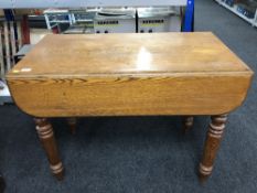 An antique pine drop leaf kitchen table
