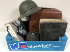 A box of WWII helmet, vintage leather case, family bible,