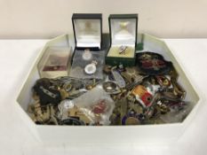 A box of a large quantity of military badges and buttons, some silver,