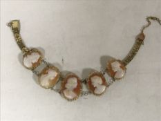 A gold five cameo panel bracelet, length 17.5 cm, 12.2g gross.