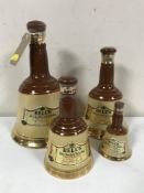 Four graduated Wade Bells Whiskey decanters (sealed)