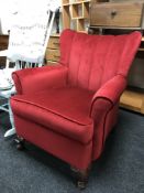 A red button dralon armchair