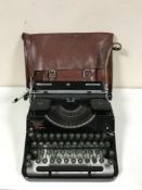 A cased Junior Empire typewriter and a 70's leather satchel