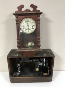 A cased Singer sewing machine and a wall clock