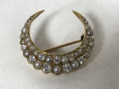 A Victorian old cut diamond and pearl crescent shaped brooch, 7.4g, width 26mm.