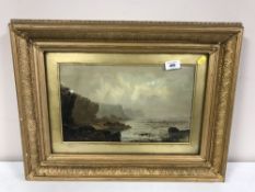 An antique oil on board depicting a coastline in gilt frame