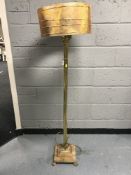A heavy brass Corinthian column standard lamp with shade