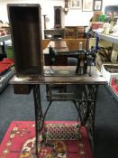 A Singer treadle sewing machine in table and a woollen hearth rug