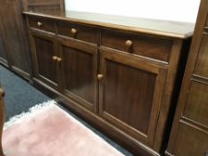 A contemporary walnut triple door sideboard