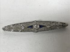 An Art Deco 14ct white gold diamond and sapphire bar brooch, length 58mm, 4.2g.