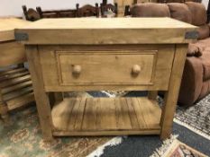 A pine butcher's block fitted with a drawer,