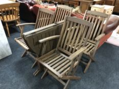 A teak garden table and four chairs