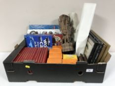 A box containing children's books, Tetley Tea folk, framed pictures of tall ships,