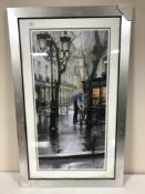 A silvered framed print of a Parisian street scene
