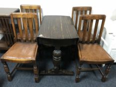 An oak drop leaf table and four chairs